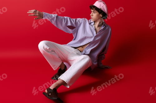 Preview: Stylish young man in bold setting showcases modern fashion and confident pose
