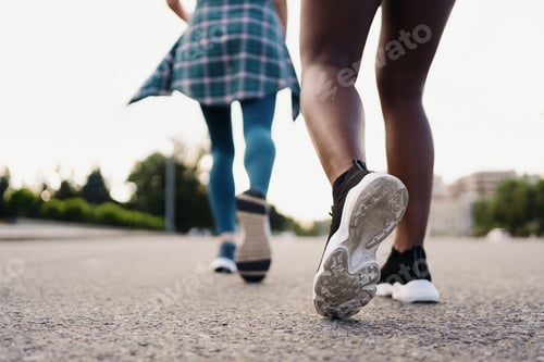 Preview: Two women legs running in the city on the road outdoors. Sports and healthy lifestyle training