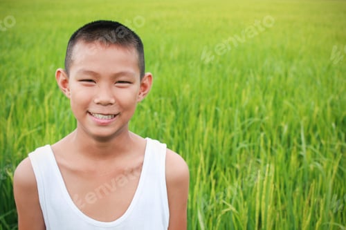 Preview: Young asian boy with green rice field background.