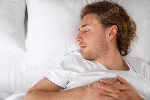 Preview: Handsome young man sleeping on pillow, top view with space for text. Bedtime
