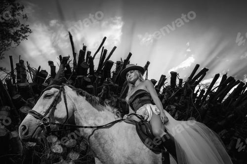 Preview: Woman in Stylish Attire Riding Grey Horse Along Woodpile