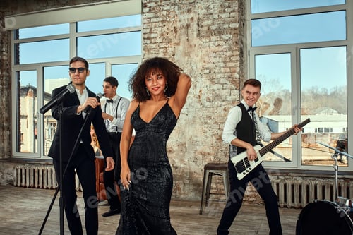 Preview: Photo of a lot of ethnic musical group in studio. Musicians and an African American woman soloist