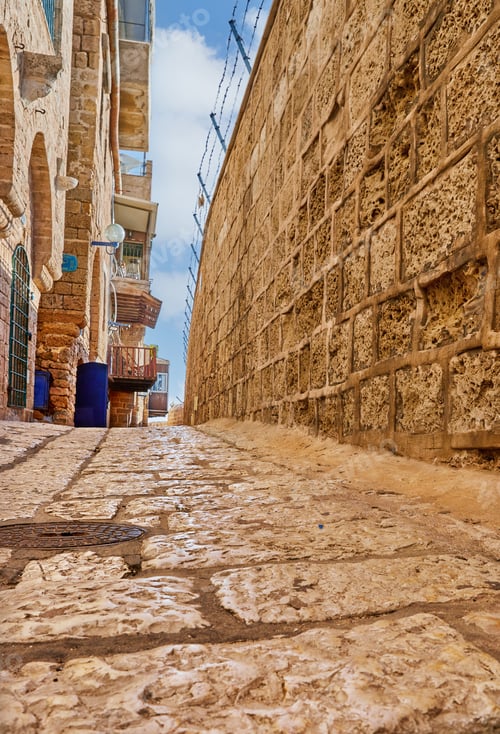 Preview: Stone narrow streets of the Old City of Jaffa against blue sky with clouds