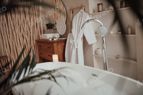 Preview: Luxury interior of big bathroom at modern african style with oval bathtub in natural lighting