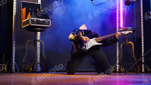 Preview: Confident female rocker performing live with a bass guitar on stage