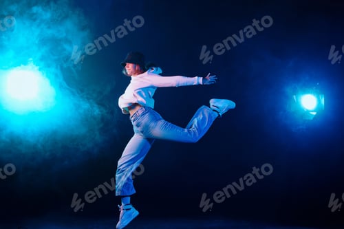 Preview: a girl in light clothes dances on a neon background in smoke, modern dance