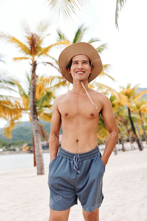 Preview: Muscled Asian Man Enjoying Summer Vacation on a Tropical Beach, Smiling and Shirtless