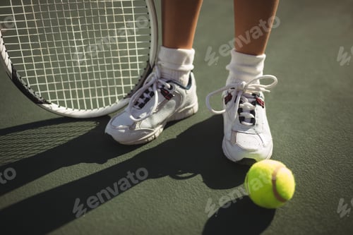 Preview: Low section of girl with racket and tennis bal