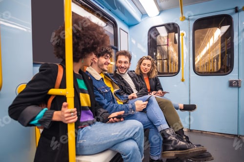 Preview: Group of four multiethnic people traveling subway using smartphone
