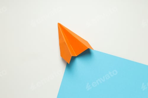 Preview: Orange paper plane on white - blue background
