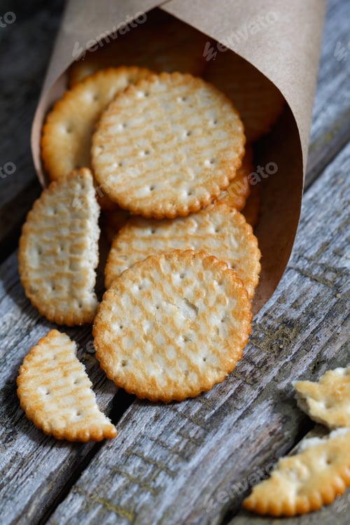 Preview: Close-up of a of salted crackers on an old wooden table.