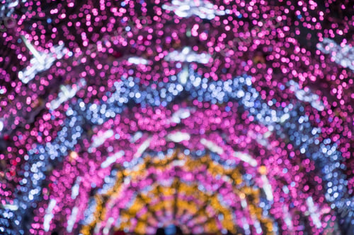 Preview: Blurred garland as arc or semicircle. City night light blur bokeh, defocused background.