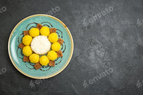 Preview: top view delicious dessert little yellow candies with cake inside plate on the grey background candy