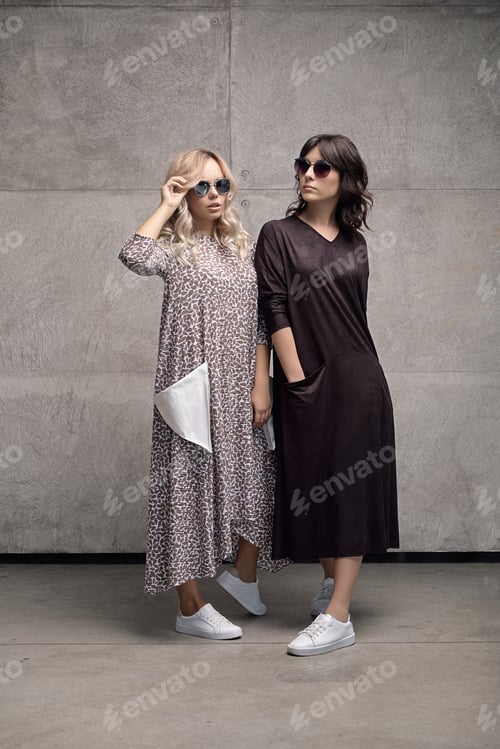 Preview: Two cheerful trendy young women wearing sunglasses