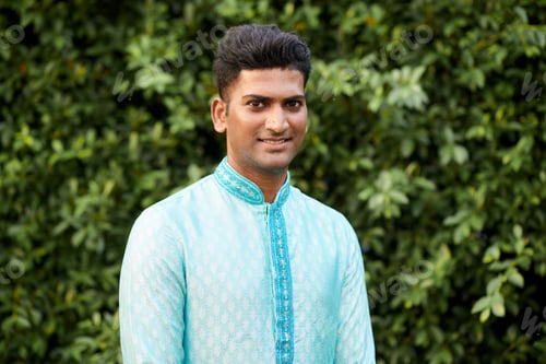 Preview: Indian Man Standing against Green Gence