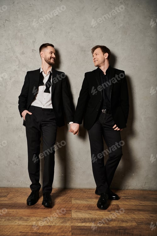 Preview: Dapper Duo in Black Suits Share a Smile