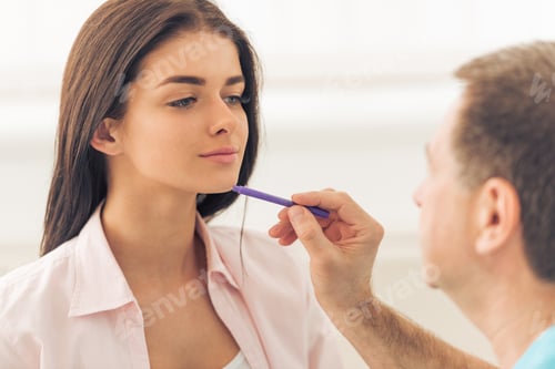 Woman Receiving Examination with Purple Stick Indoors