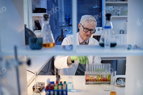 Preview: Senior Caucasian Man Scientist Conducting Chemical Experiment in Laboratory