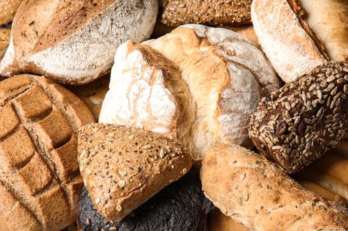 Preview: Different kinds of fresh bread as background, closeup