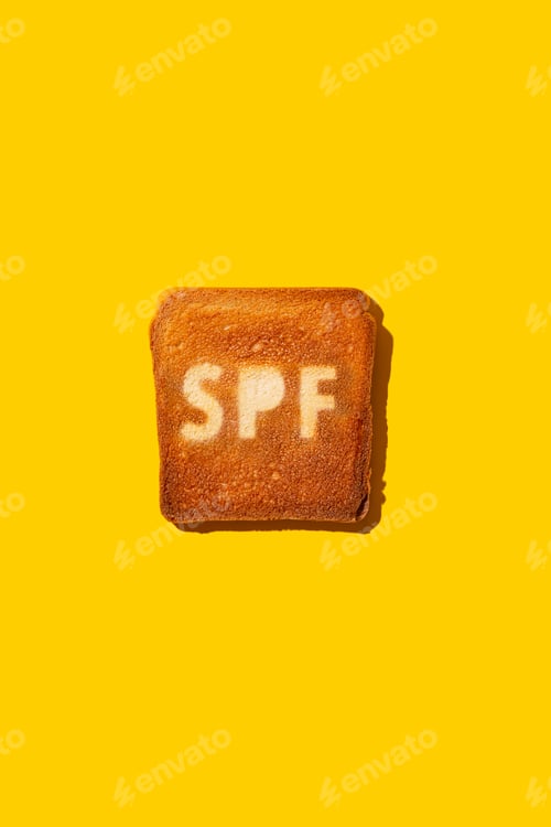 Preview: Concept of SPF cream on toasted bread. Yellow background.