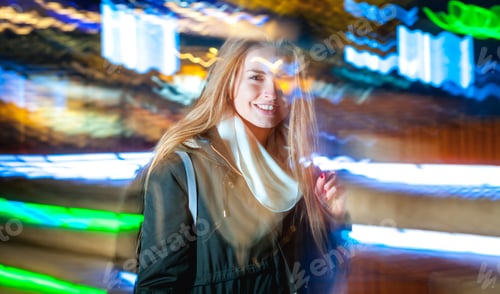 Preview: Woman in city at night among neon moving lights