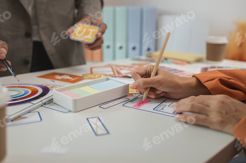 Preview: UI UX designers team working on new website wireframe in office