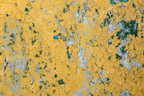 Preview: cracked yellow paint on blue concrete wall