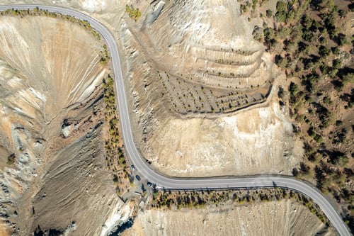 Preview: Aerial top drone view mountain landscape with empty curved road