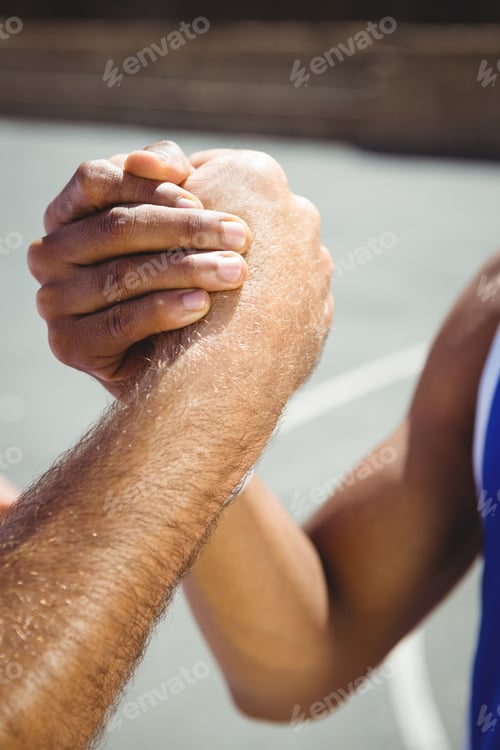 Preview: Cropped image of male basketball players holding hands