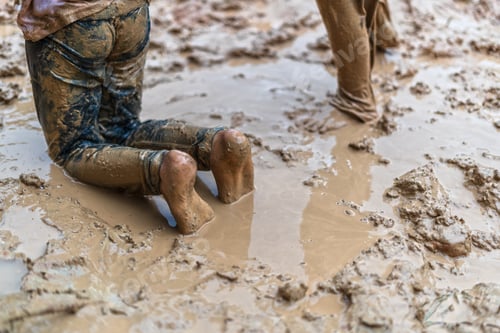 Preview: Child's feet stomping in a mud puddle