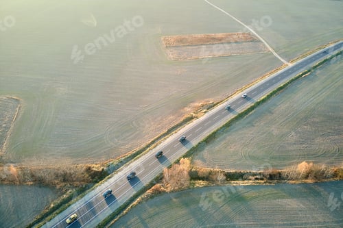 Preview: Aerial view of intercity road with fast driving cars at sunset. Top view from drone of highway