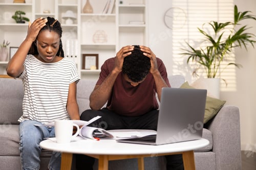 Preview: Stressed Couple Managing Finances With Laptop And Documents