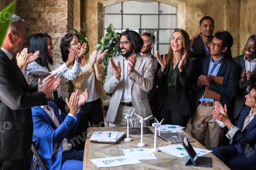Preview: Group of workers of different ethnicities applauding at the end of the meeting