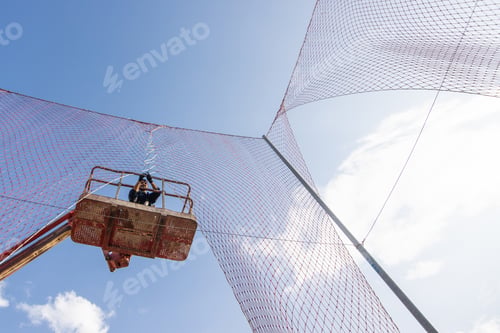 Preview: Low angle shot of a man working at a construction site - concept of construction