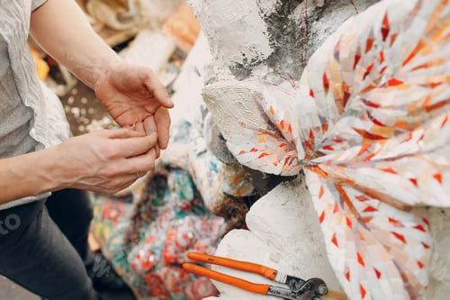Preview: Workplace mosaics master making smalt glass mosaic panel. Man mosaicist at work