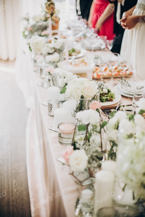 Preview: Stylish luxury centerpiece with floral decor, pink cloth, glasses and delicious food