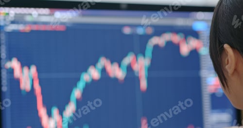 Preview: Woman work on computer with stock market at home