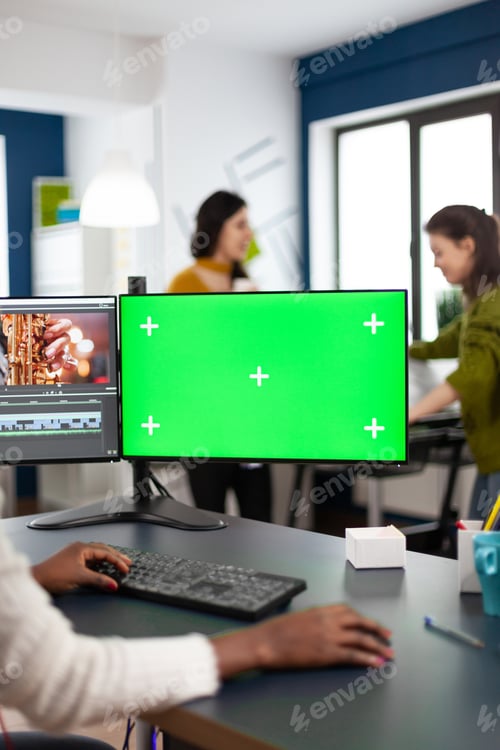 Preview: Black woman video editor with headphones using with green screen