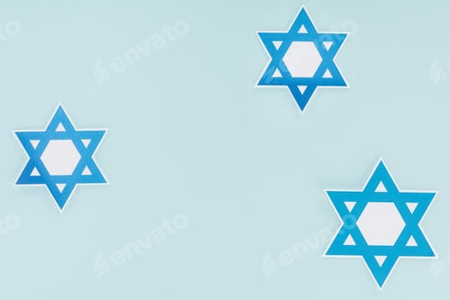 Preview: flat lay with traditional jewish stars isolated on blue, hannukah holiday concept