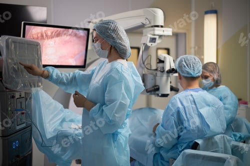 Preview: Female Surgeon Operating with Team in Modern Medical Operating Room