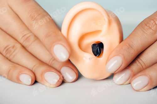 Preview: Close-up of hearing aid on human ears model