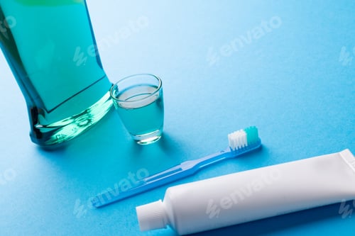 Preview: Image of cleaning liquid, toothbrush and toothpaste on blue surface