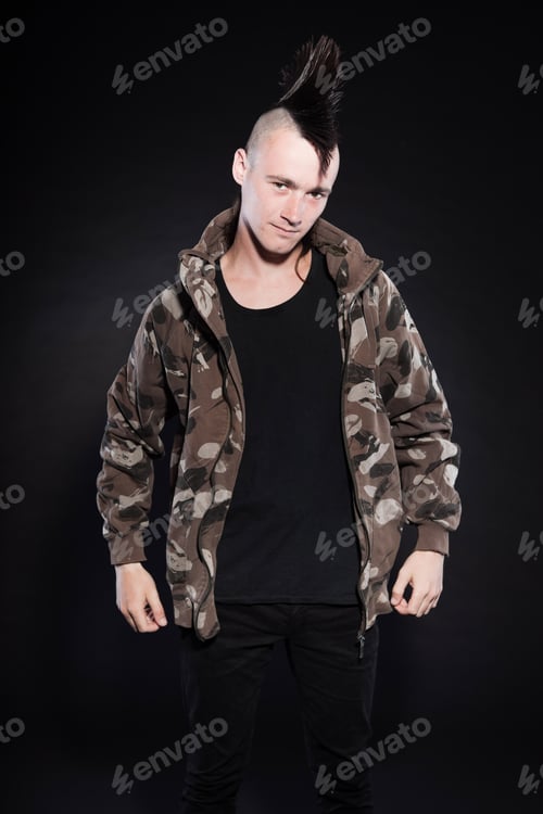 Preview: Punk Man With Mohawk Haircut. Expressive Face. Army Camouflage Jacket. Isolated On Black