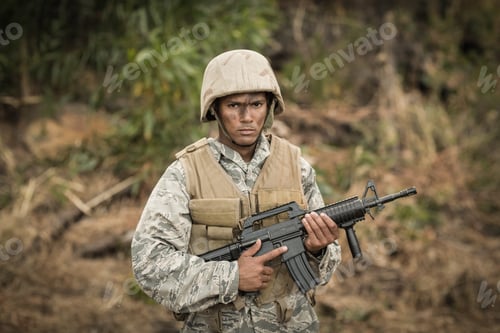 Preview: Military soldier guarding with a rifle in a boot camp