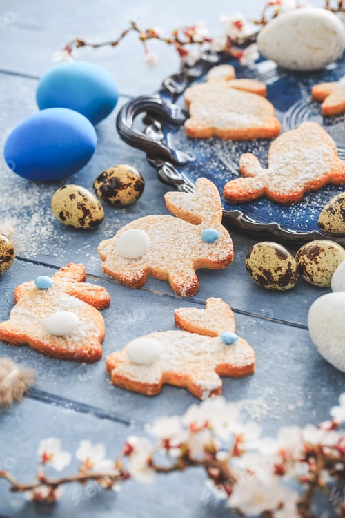 Preview: Homemade almond bunny cookies for Easter with Easter eggs in blue tone