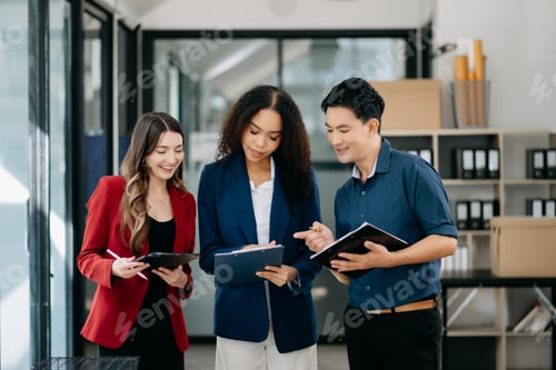 Preview: Happy businesspeople while collaborating on a new project in an office.