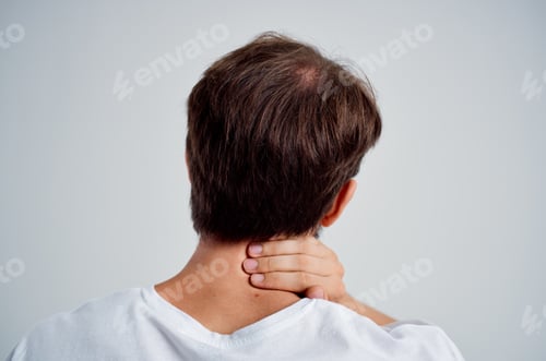 Preview: man in a white t-shirt stress medicine pain in the neck studio treatment