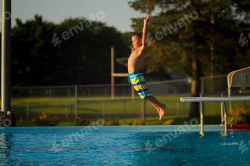 Preview: Boy jumping off diving board into pool
