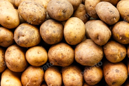 Preview: Stack of potatoes in a market stand.