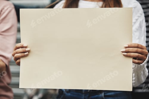 Preview: Cropped shot of an unrecognizable woman holding a sign while taking part in a political rally